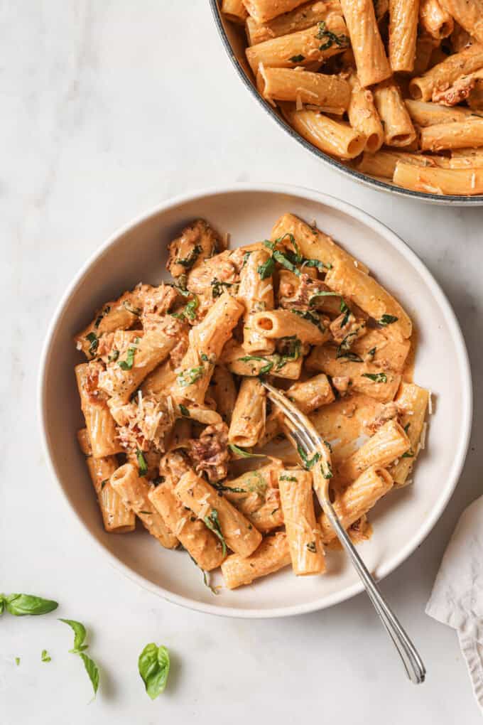 marry me pasta in a white bowl with a fork