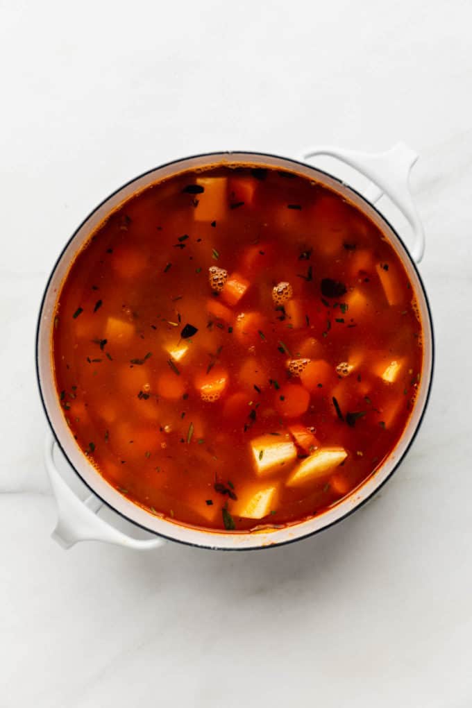 Uncooked lentil stew in a white pot